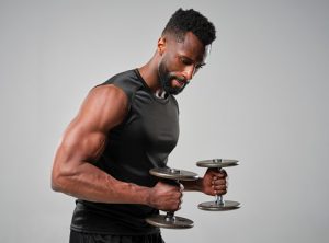 man getting strong with dumbbell